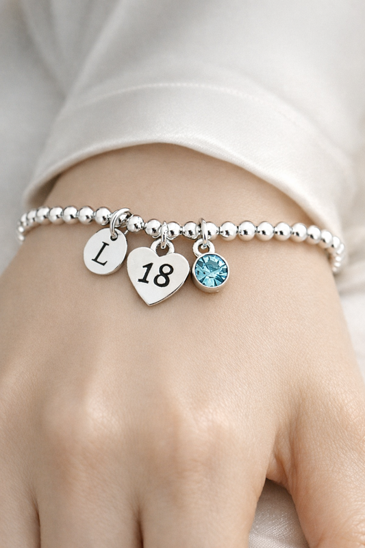 Personalised 18th birthday bracelet with initial, birthstone and number 18 charm
