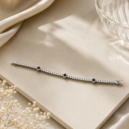 Brilliant cut CZ tennis bracelet with black clovers