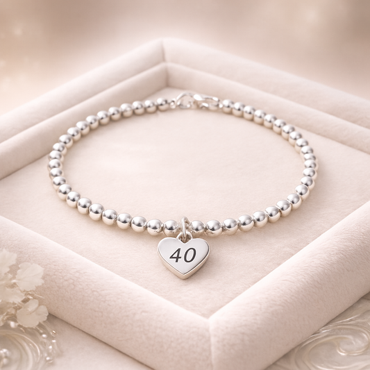 Milestone 40 keepsake bracelet displayed on a soft velvet background