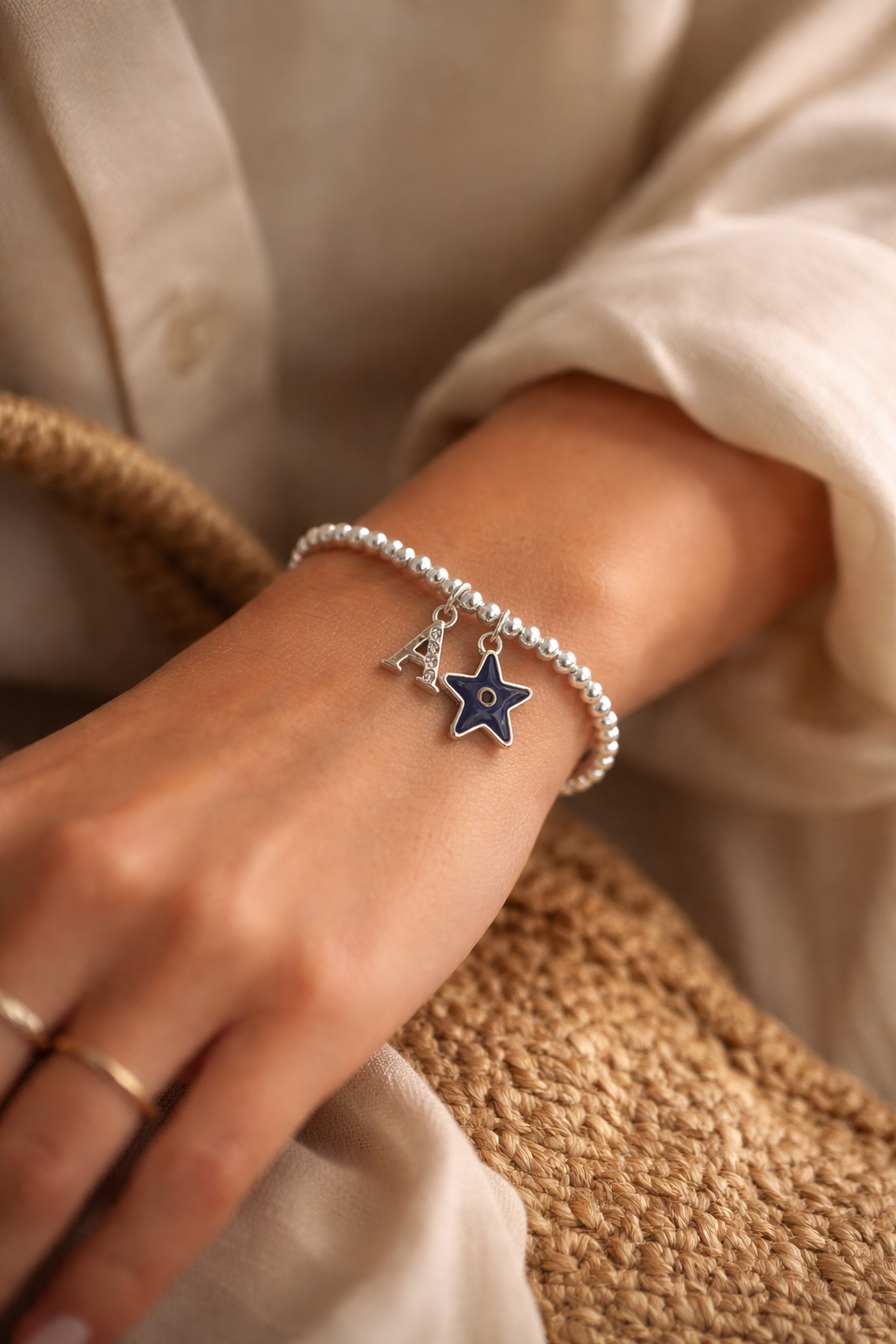 Personalised silver beaded bracelet with star evil eye charm