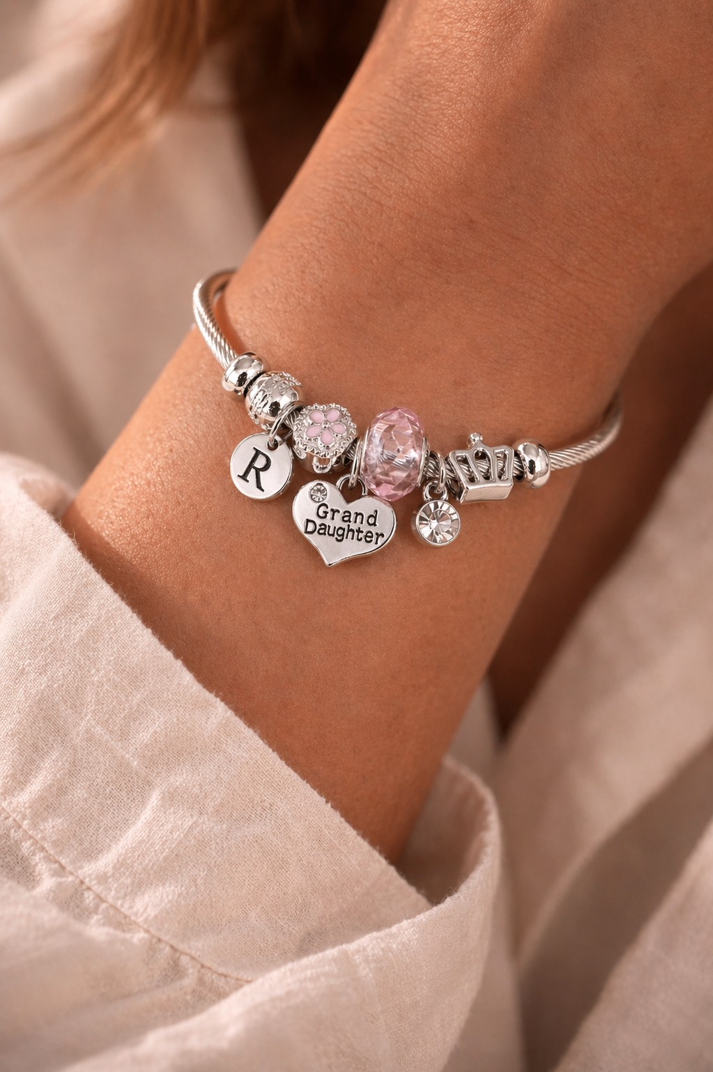 Personalized granddaughter charm bracelet with initial and birthday charms