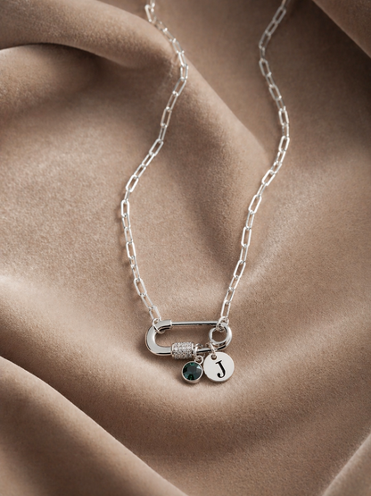 Woman wearing personalized silver necklace with initial and birthstone