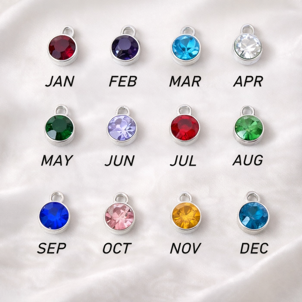  twelve birthstone charms with corresponding months on a white background
