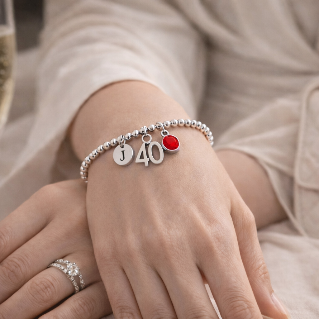woman wearing personalised 40th birthday bracelet with initial charm